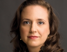 Laura Raichovich, a woman with brown hair smiles slightly. 